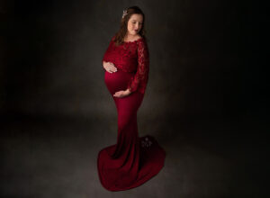 Austin Prenatal Massage expecting mom posing in red dress