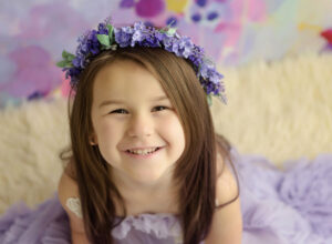 Experience Austin Baby Photography young firl in purple dress with flower crown