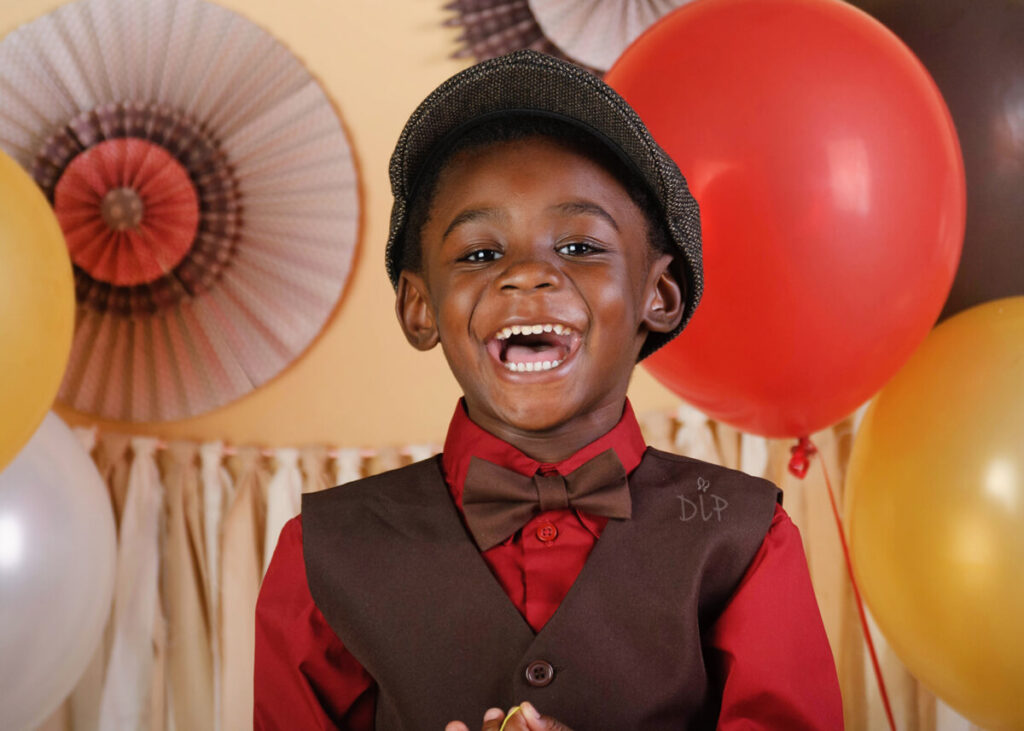 Experience Austin Baby Photography young boy in red shirt laughing