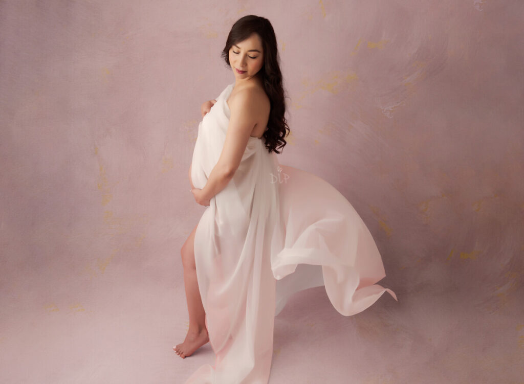 Austin Maternity Photographer expecting mom draped in white fabric