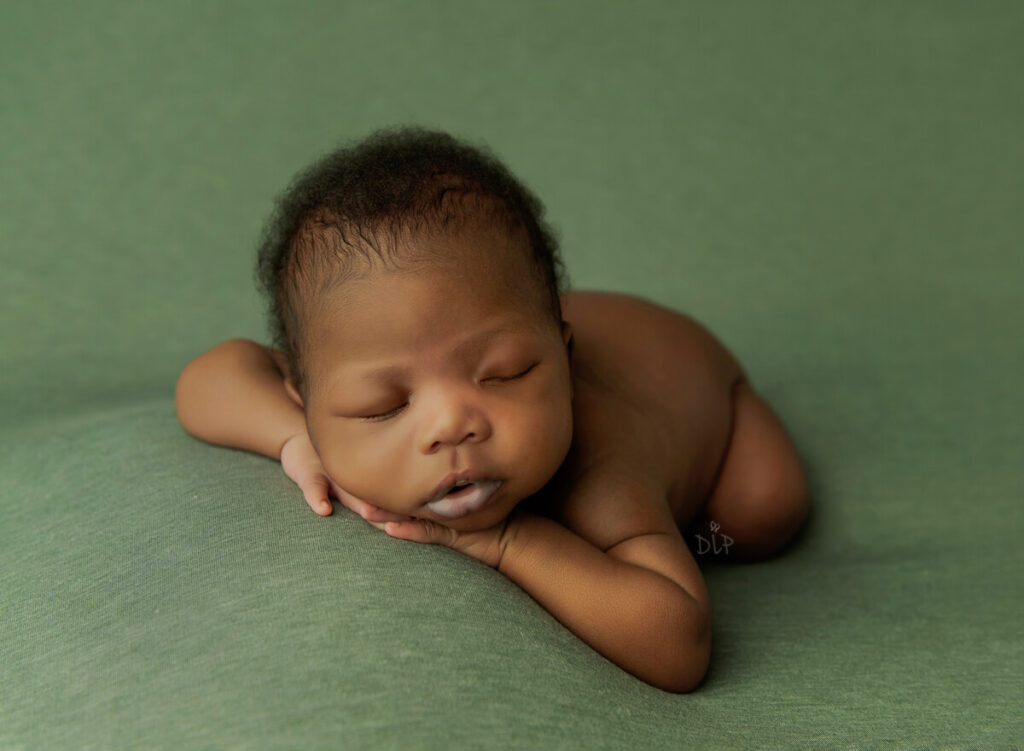 Austin Newborn Photographer baby boy on green fabric background