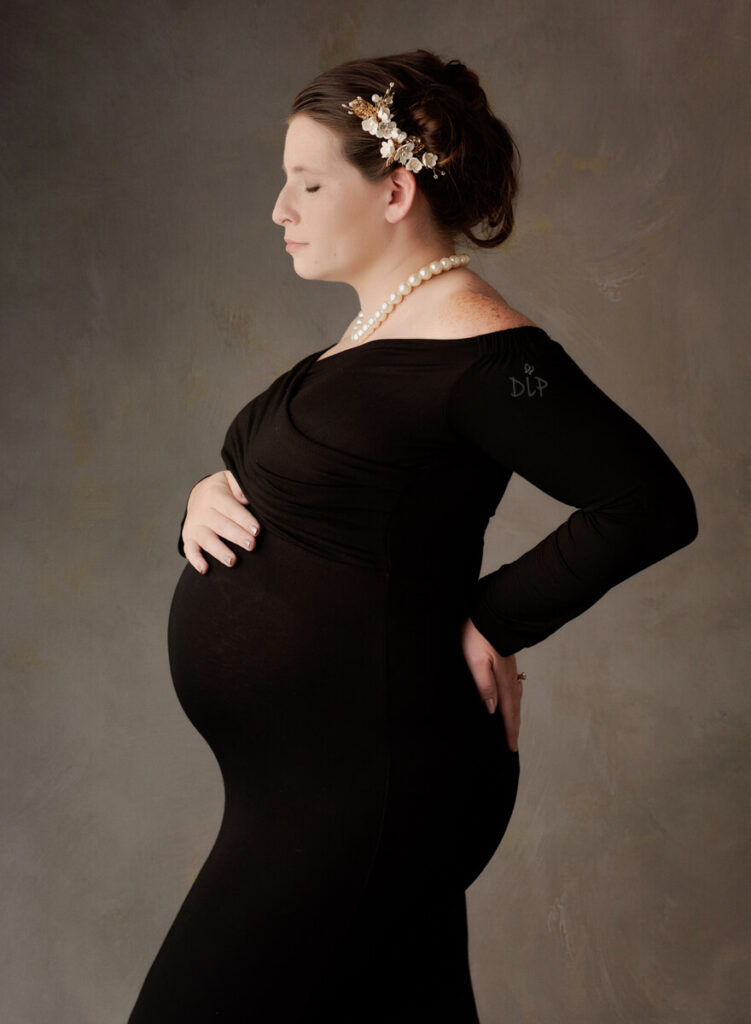 Austin Maternity Photographer expecting mom posing in black gown
