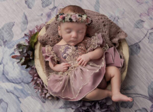 Austin Newborn Photographer baby girl in mauve outfit in cream bowl with flowers