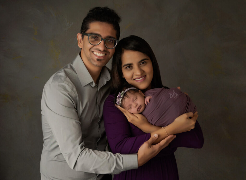 Austin Newborn Photographer baby girl in purple with parents 