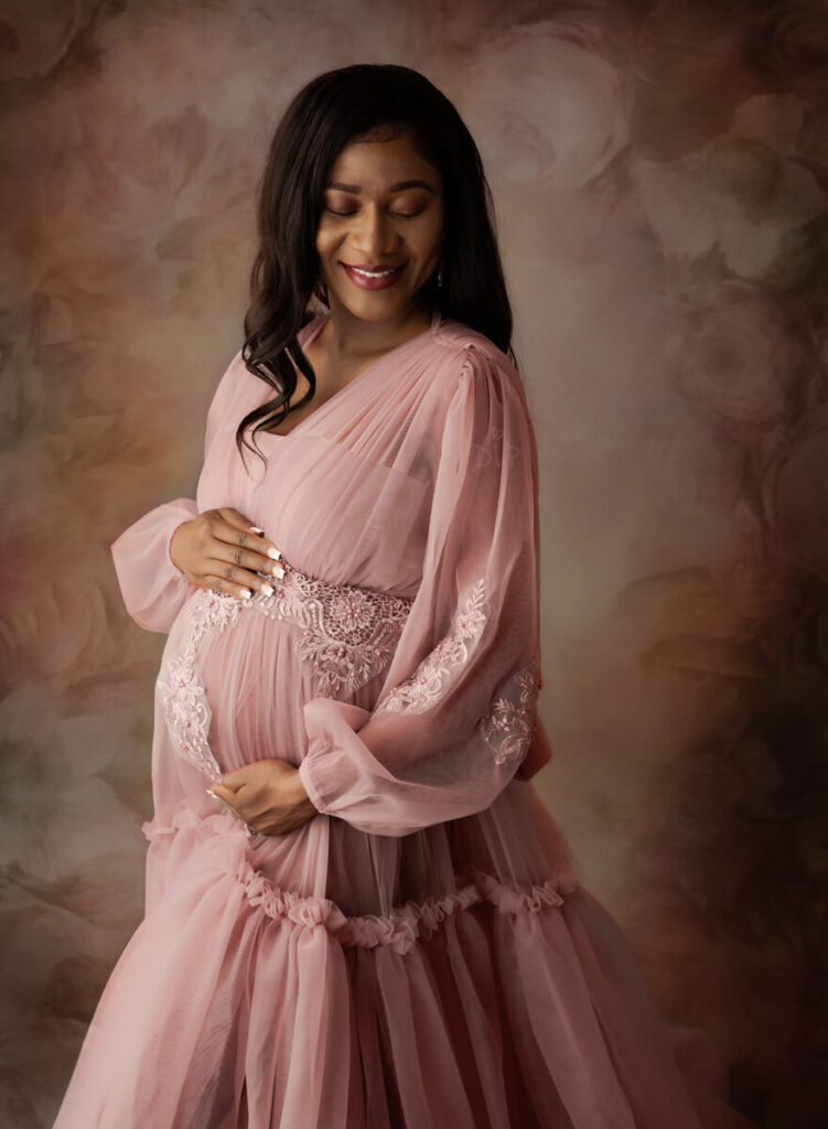 Austin Maternity Photographer expecting mom posing in mauve flowy gown