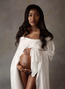 Austin Maternity Photographer expecting mom draped in white fabric