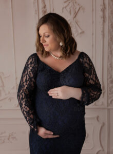 Austin Maternity Photographer expecting mom posing in navy lace gown