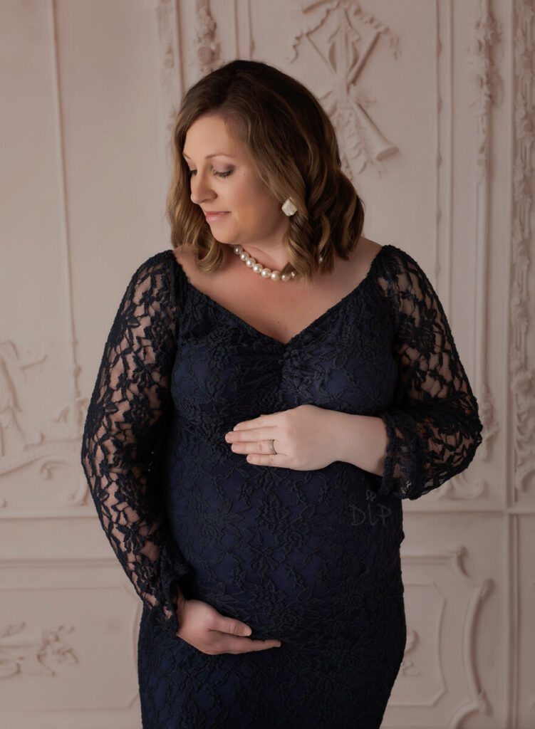 Austin Maternity Photographer expecting mom posing in navy lace gown