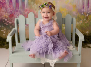 Austin Baby Photographer girl in purple dress with flowers