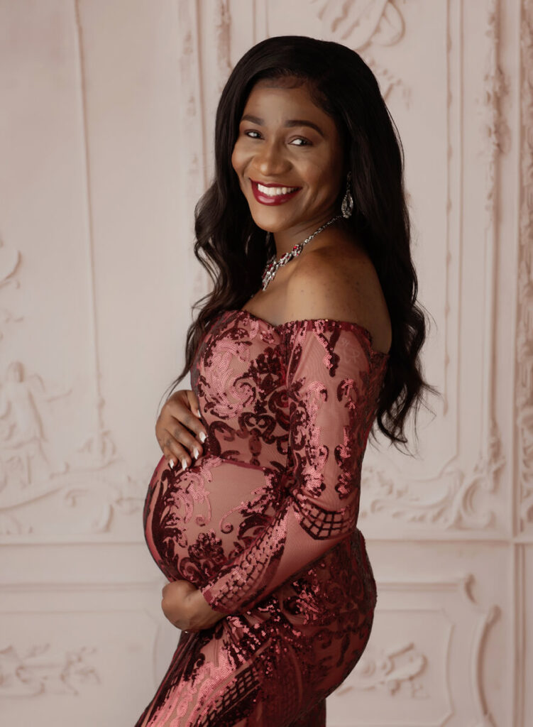 Austin Maternity Photographer expecting mom posing in formal red gown