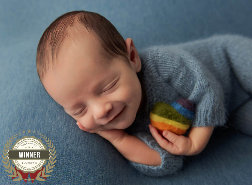 Austin Newborn Photographer baby boy smiling in blue outfit