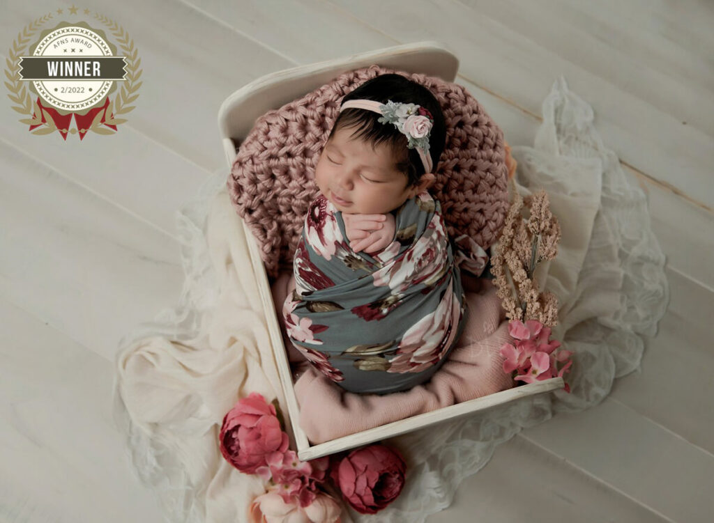 Special offer by Austin Newborn Photographer baby girl with floral wrap in white bed