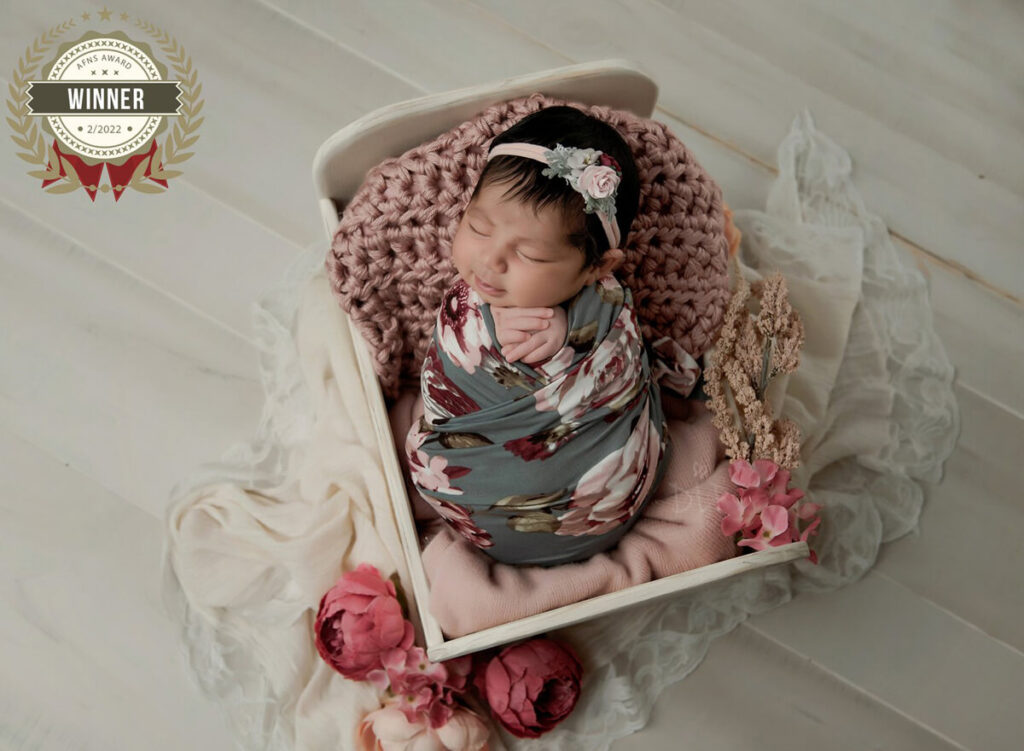 Austin Newborn Photographer baby girl with floral wrap in white bed