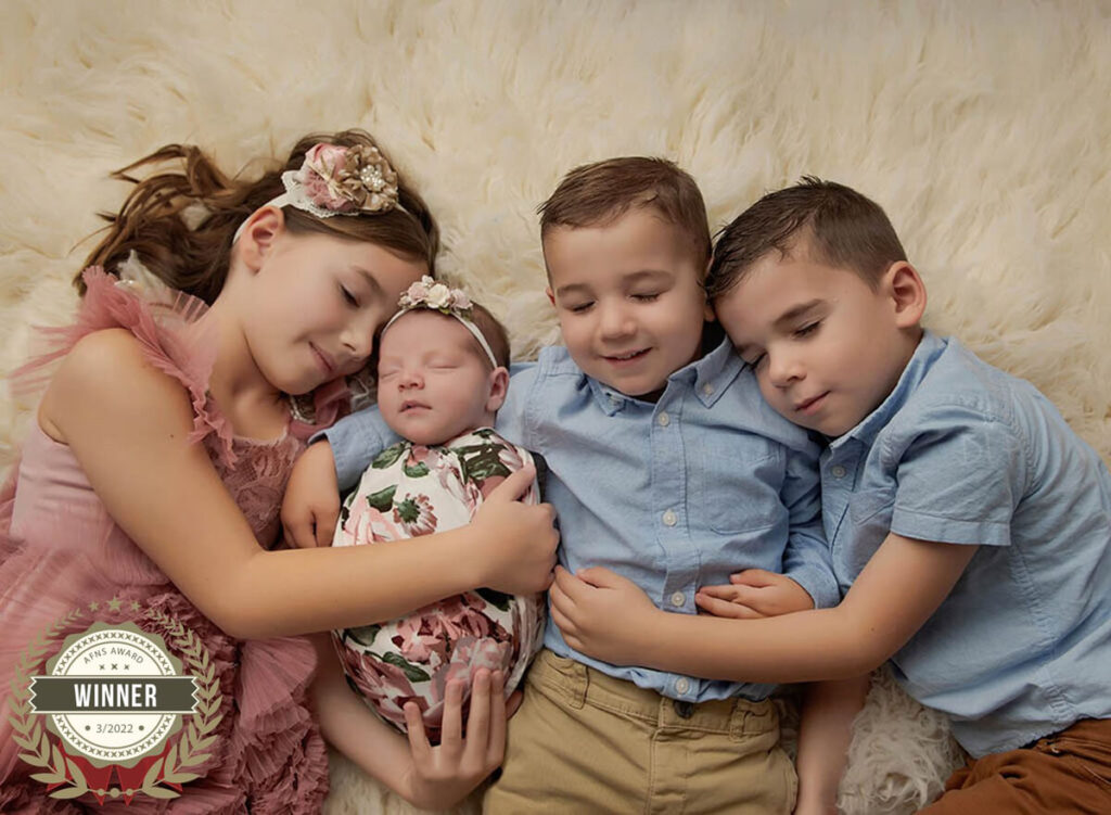 Austin Newborn Photographer baby girl in floral wrap with 3 older siblings