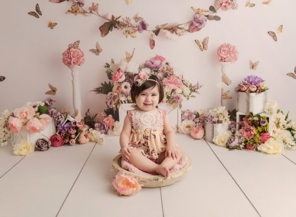 Experience Austin Baby Photographer little girl sitting in bowl with pink flowers